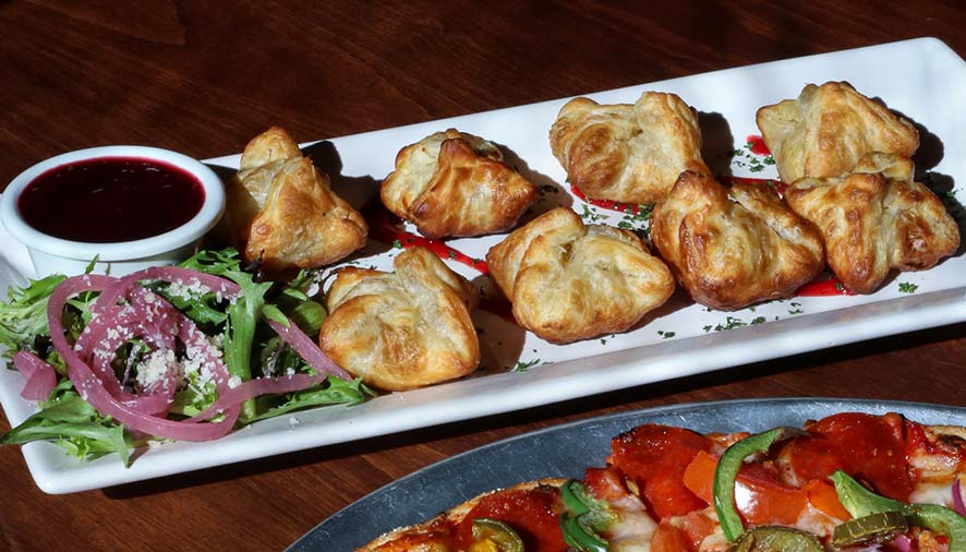 Golden puff pastry bites on a plate—perfect for restaurant catering or banquet room events.