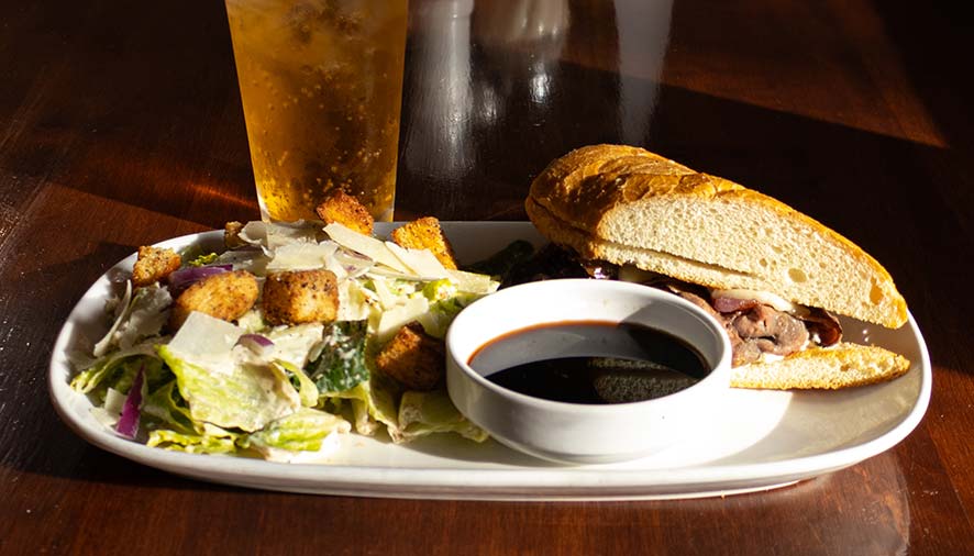A sandwich, Caesar salad, and a drink served Idaho-style at Smoky Mountain Pizzeria Grill.