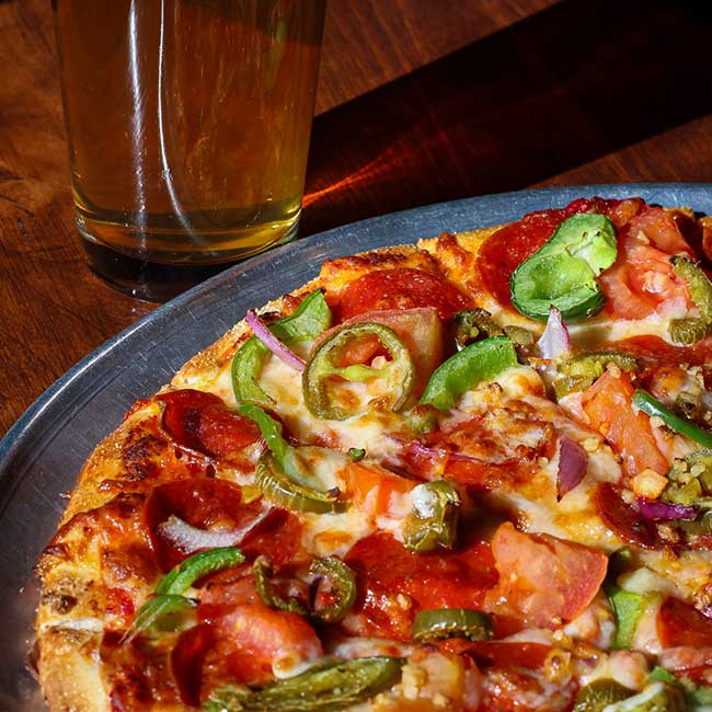 Close-up of a pepperoni and vegetable pizza, perfect for Idaho Banquet Room catering events.