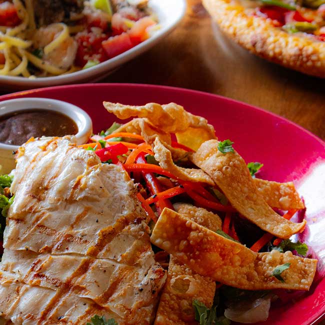 Grilled chicken salad with crispy wontons, with pasta and pizza from Smoky Mountain Pizzeria Grill.
