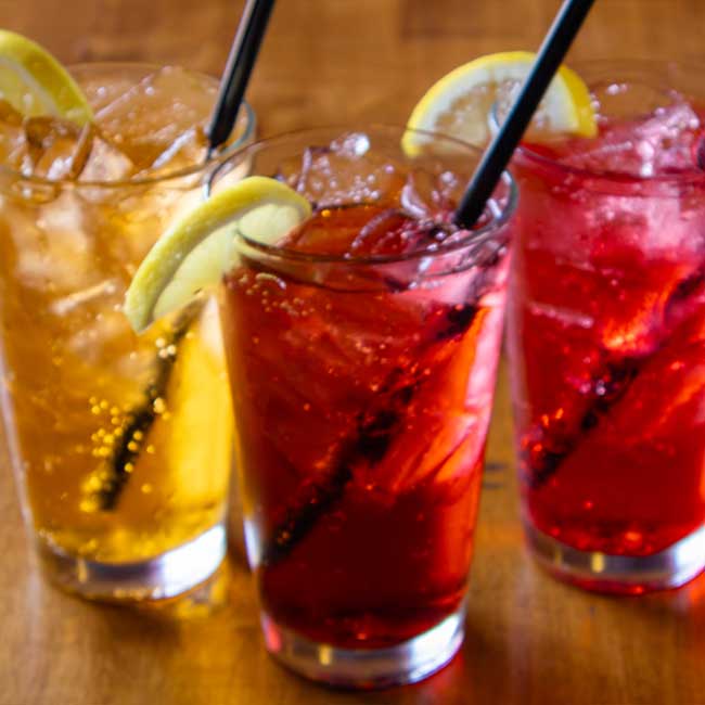 Three iced drinks in tall glasses with lemon, perfect for your Idaho banquet room catering event.