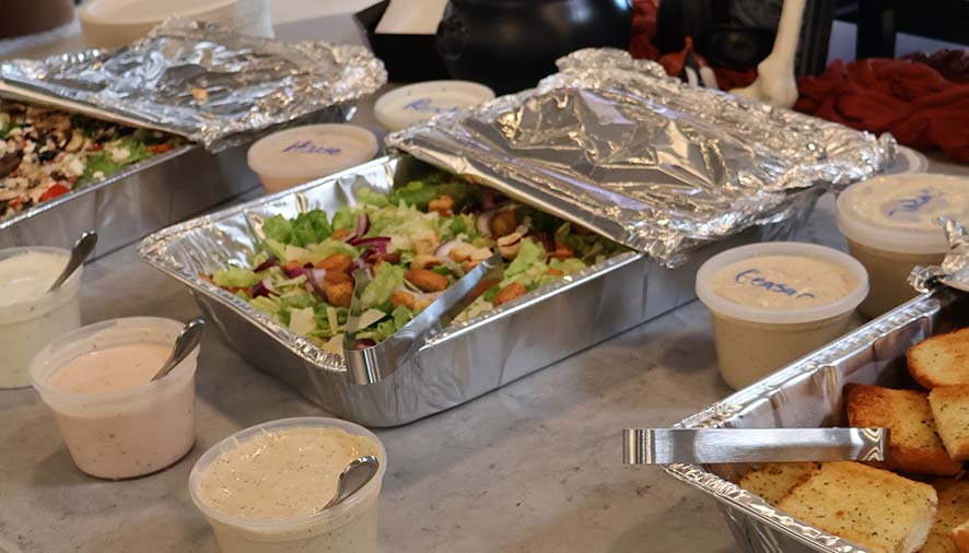 Catering trays with salad and garlic bread set for events in {city} Idaho.